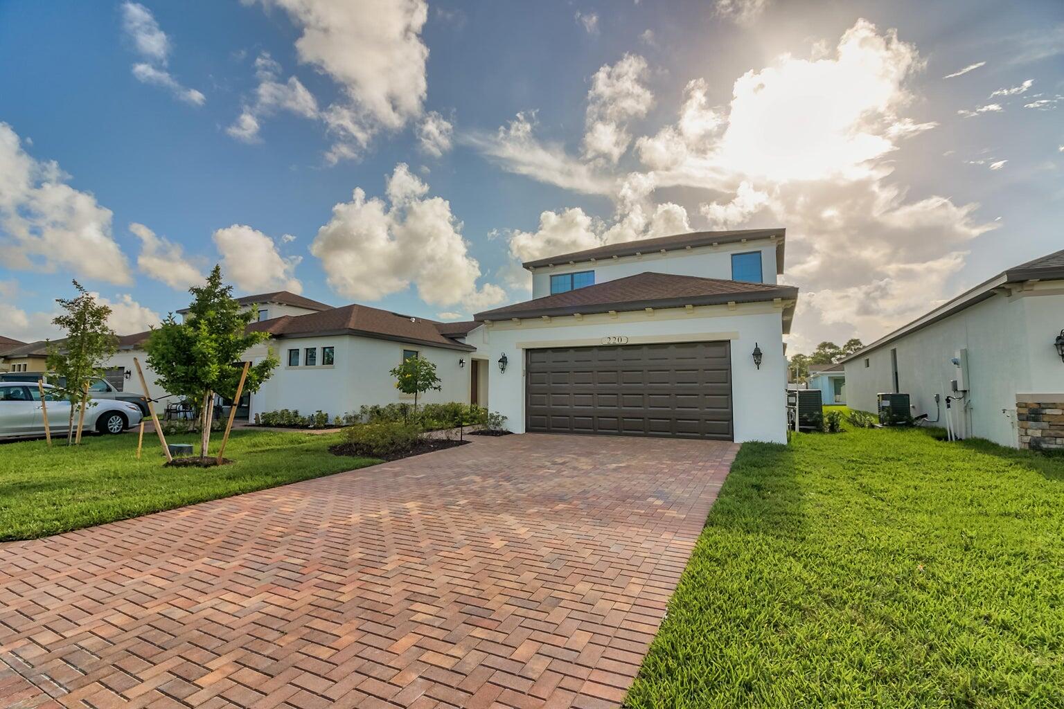 a front view of a house with a yard and garage