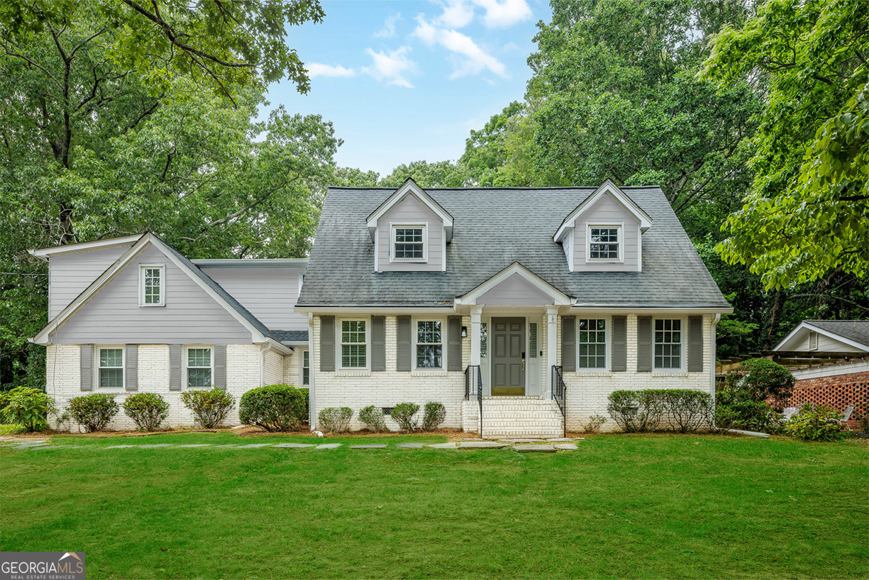 a front view of a house with a garden