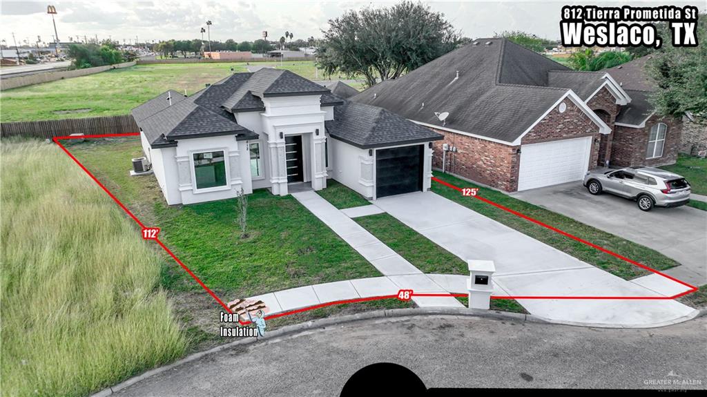 View of front of house with a garage, a front lawn, and central AC