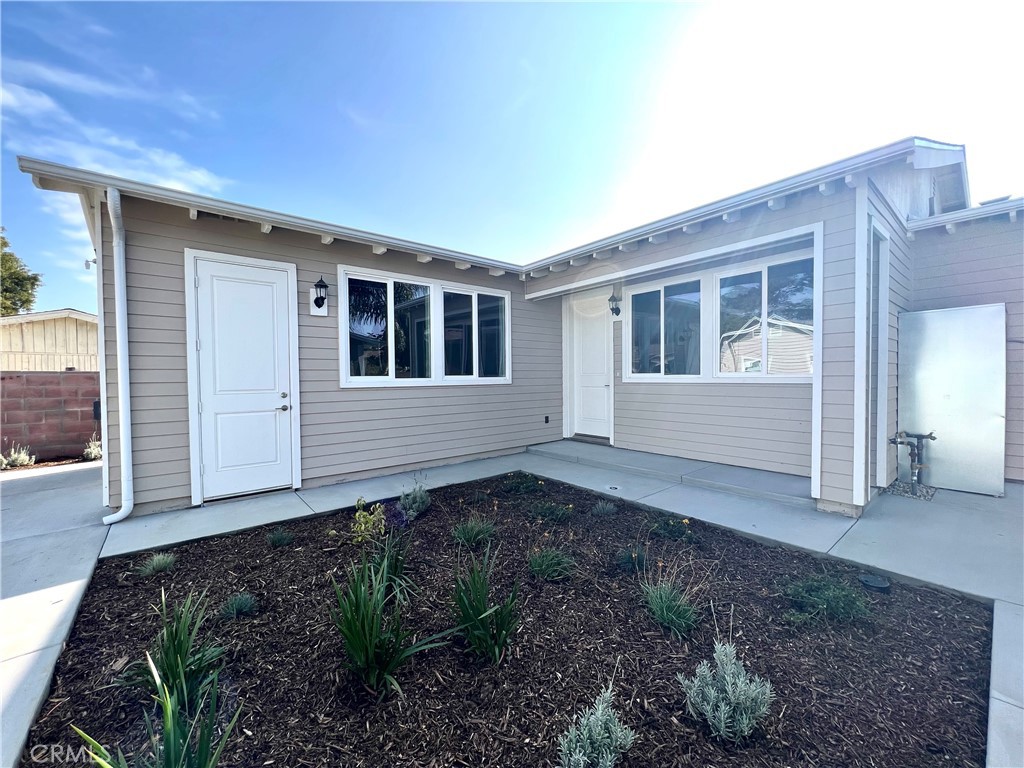 a view of house with backyard of house