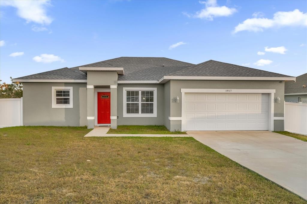 a view of a house with a yard and garage