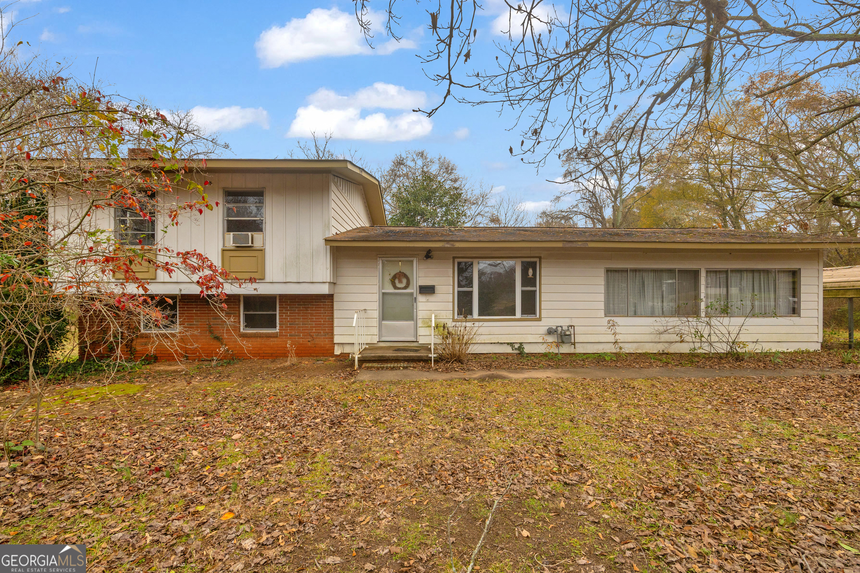 front view of a house with a large tree