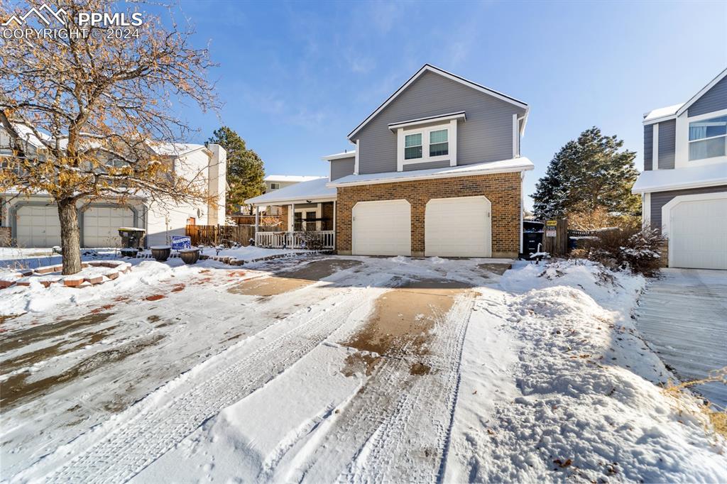 a view of a white house with a yard covered in snow