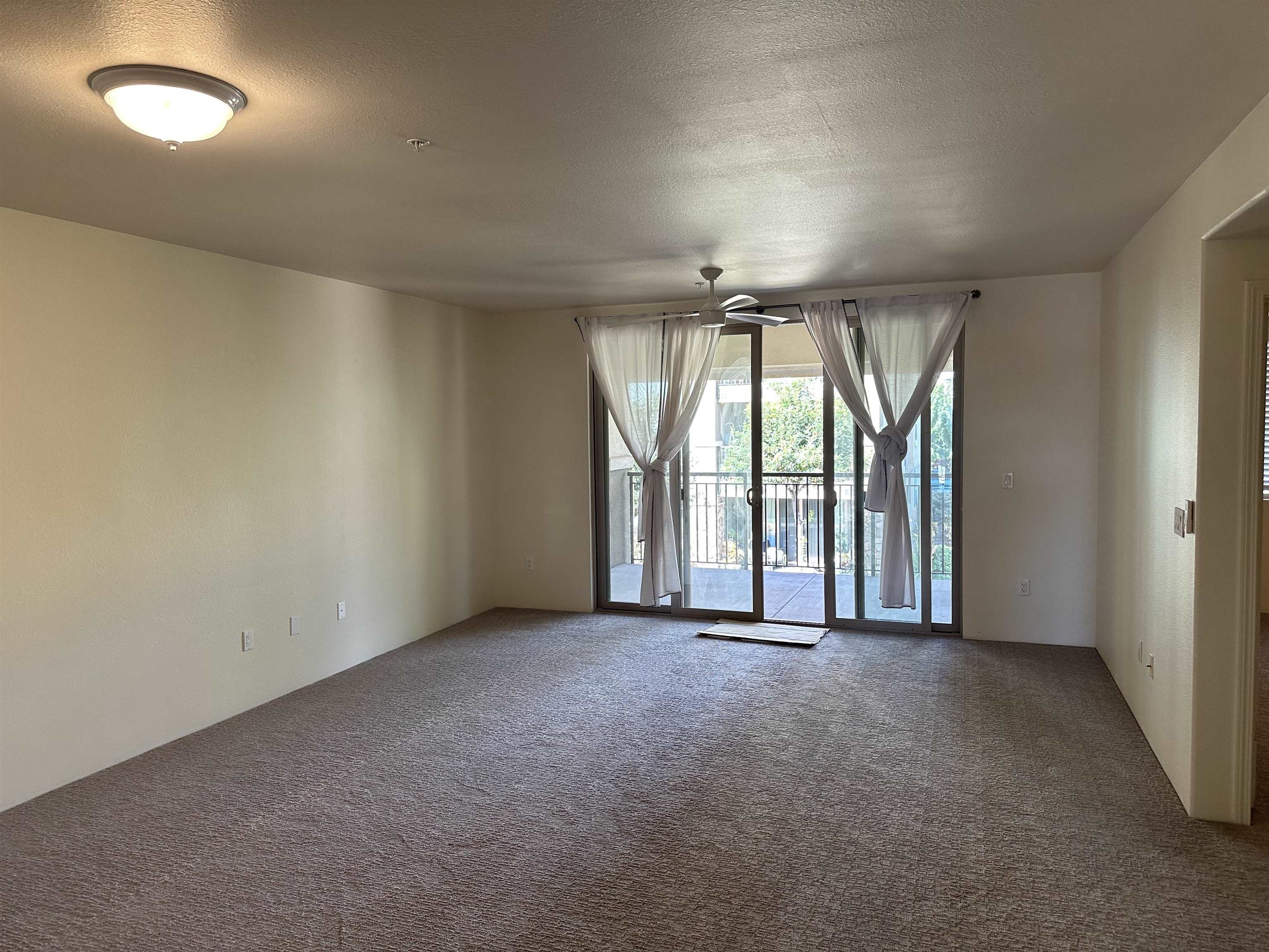 an empty room with windows and city view