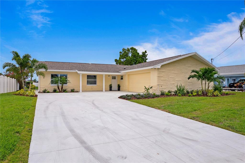 a front view of house with yard and green space