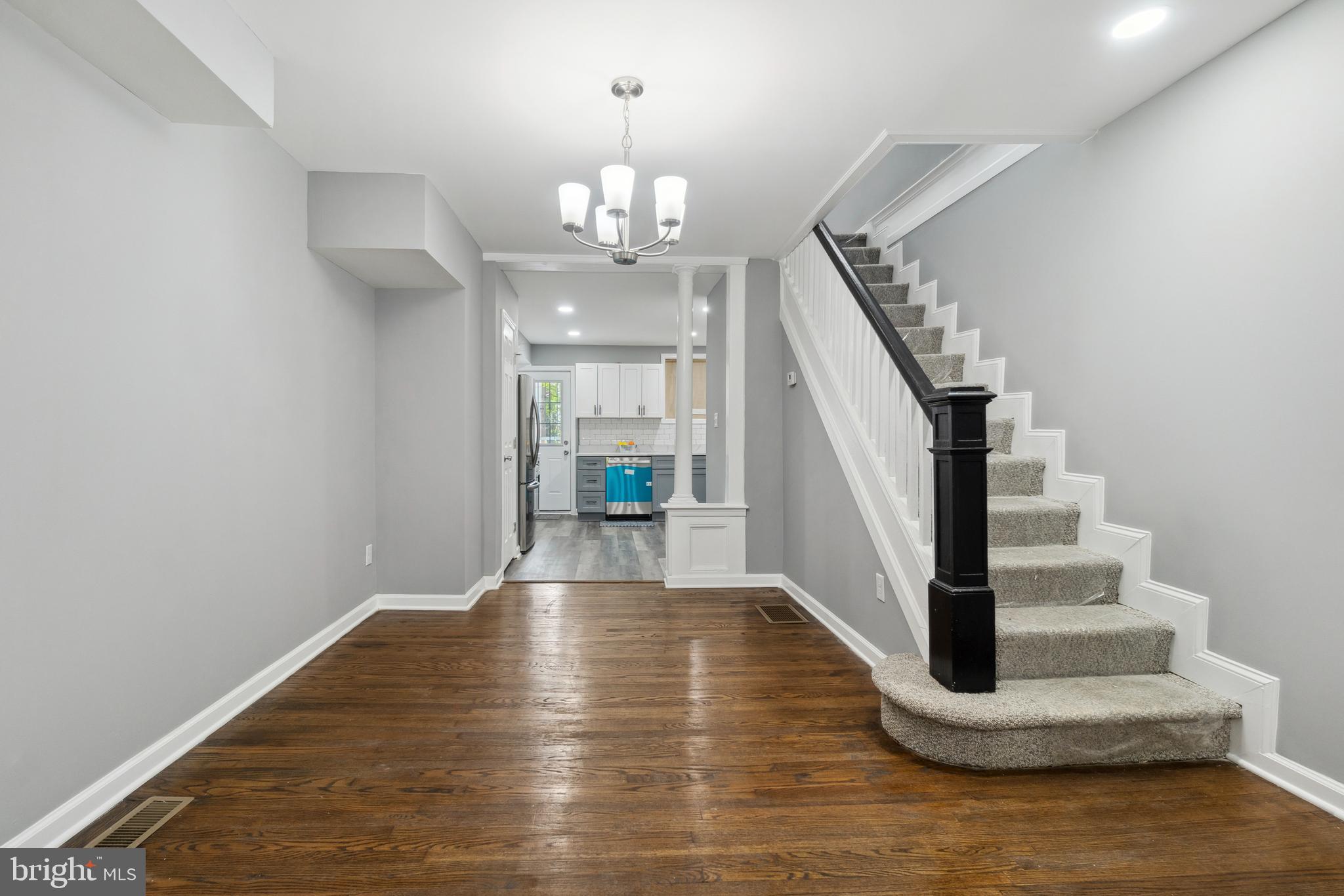 a view of entryway and hall with wooden floor