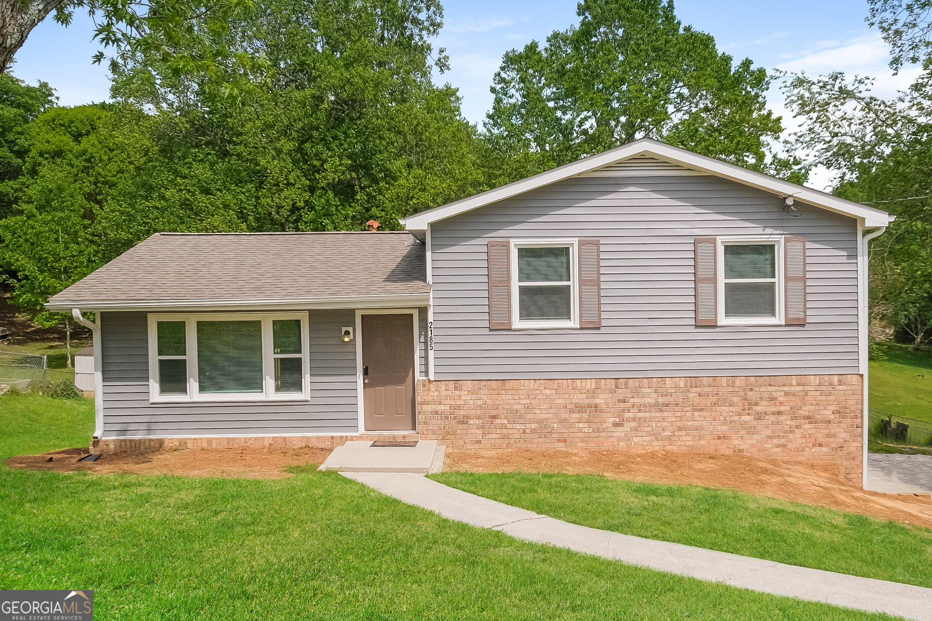 a front view of a house with a yard