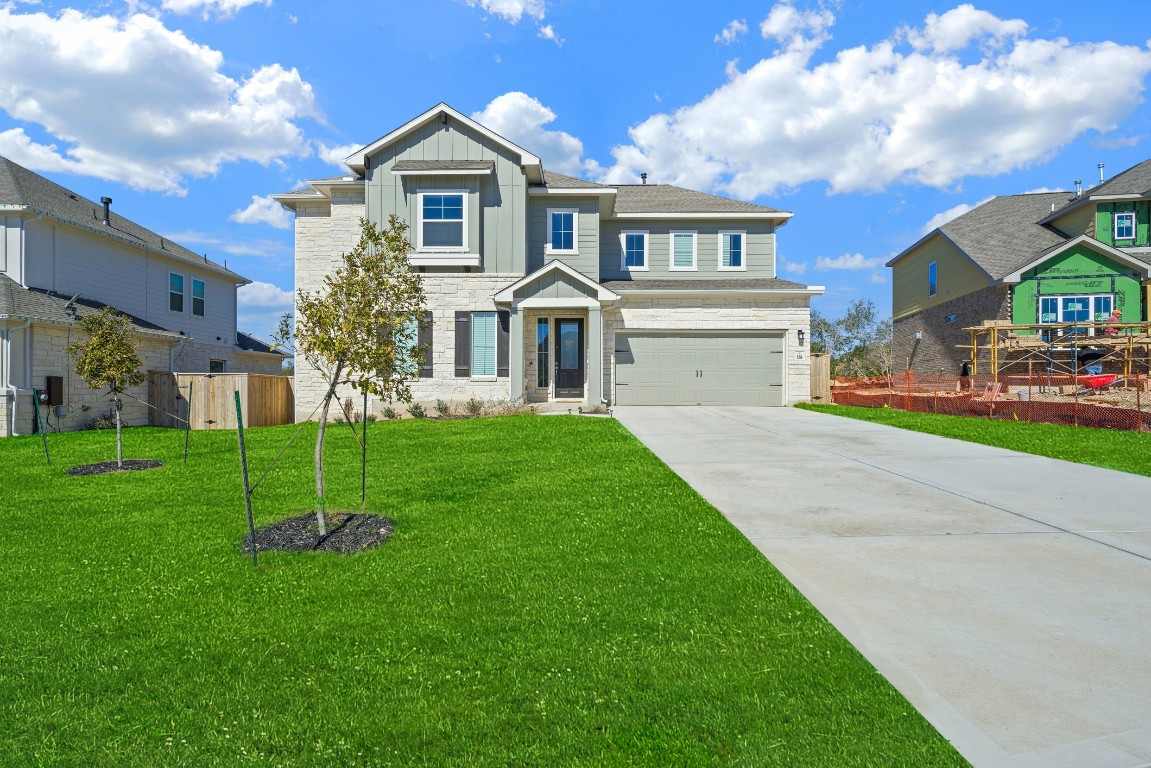 a front view of house with yard and green space