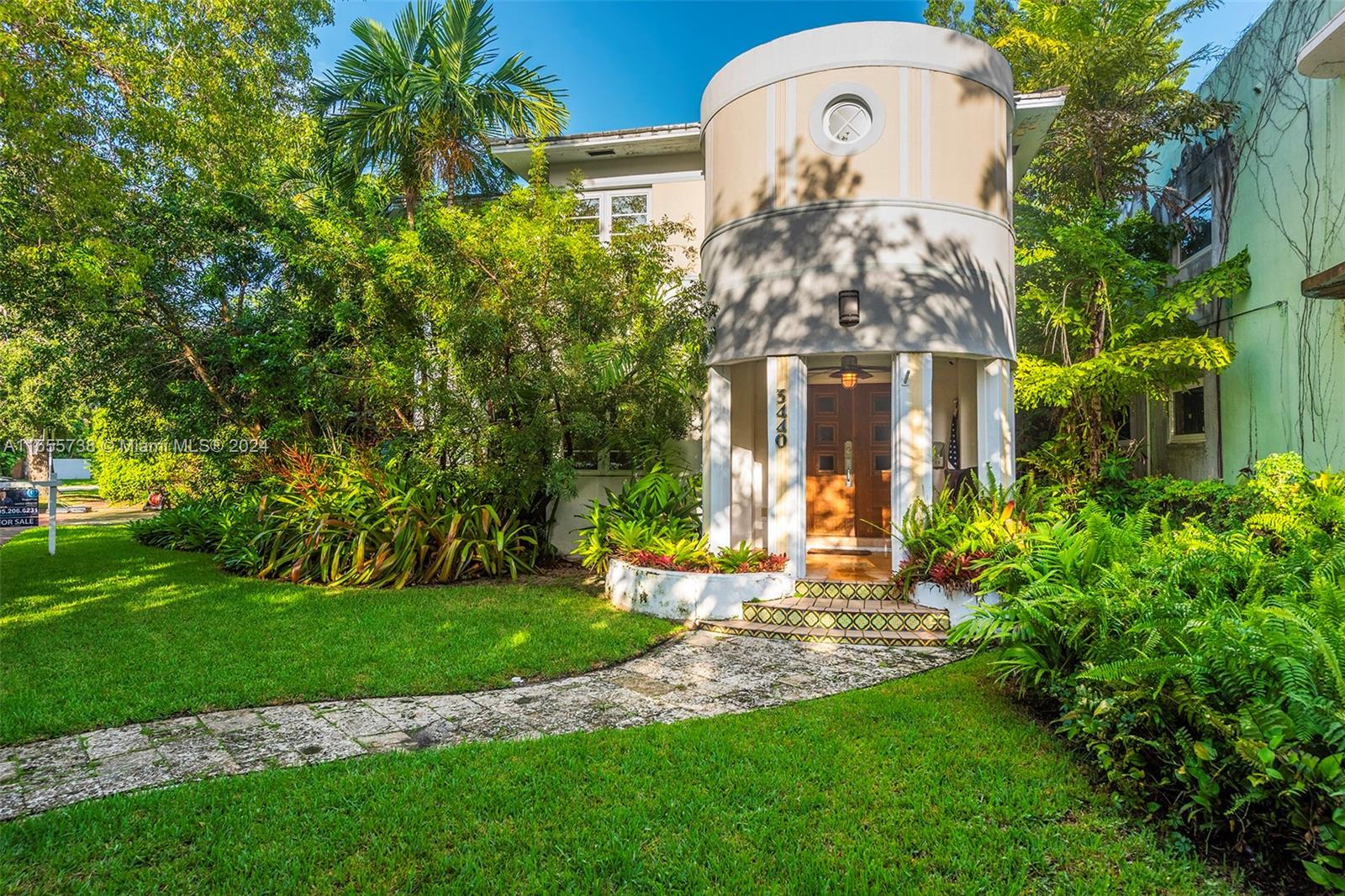 a front view of a house with a garden