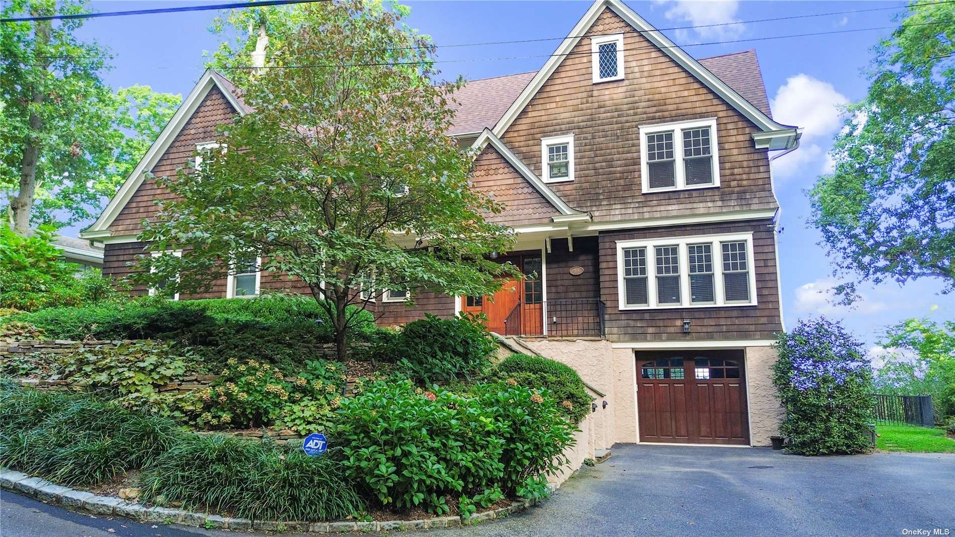 a front view of a house with a garden