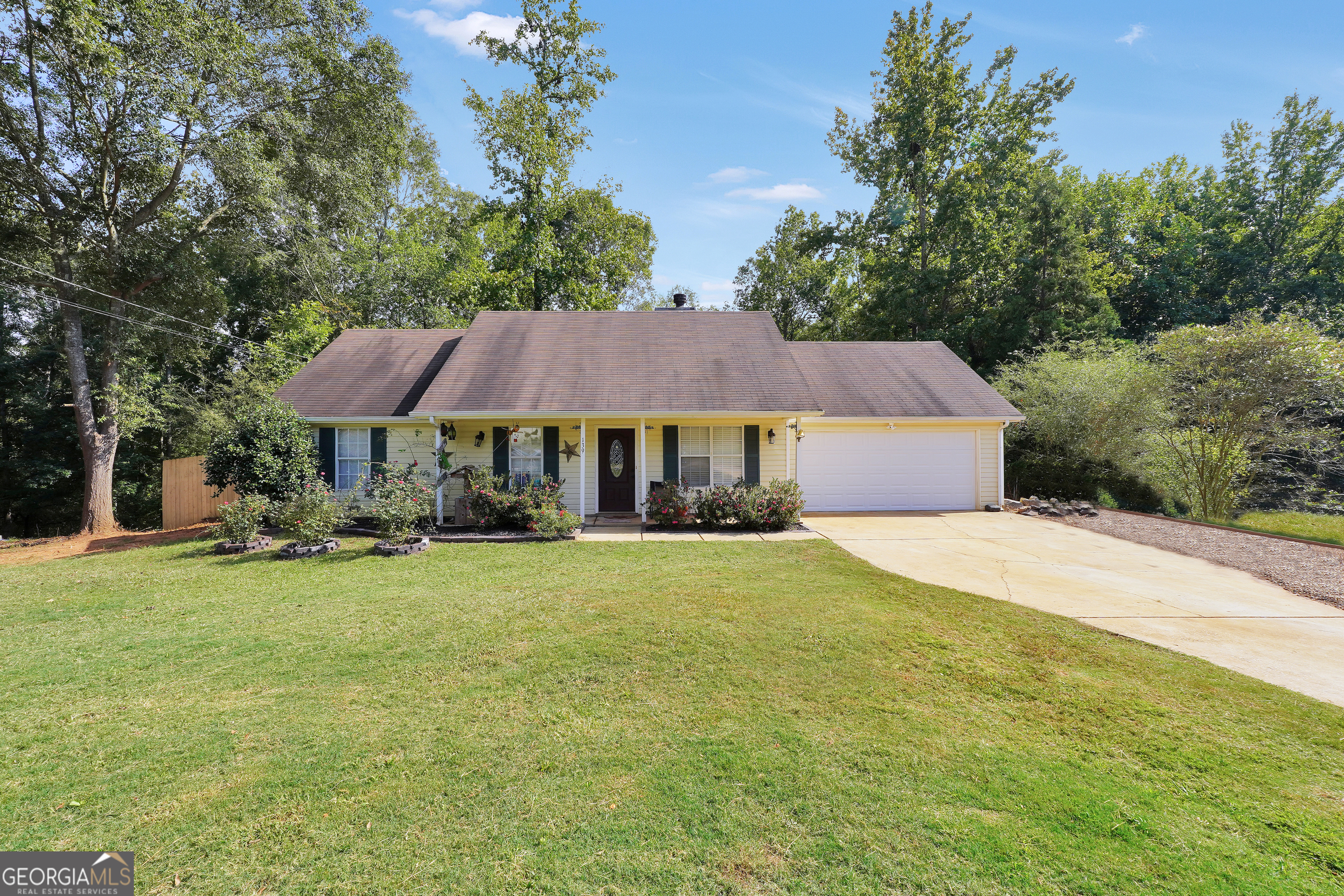 a front view of house with yard and trees