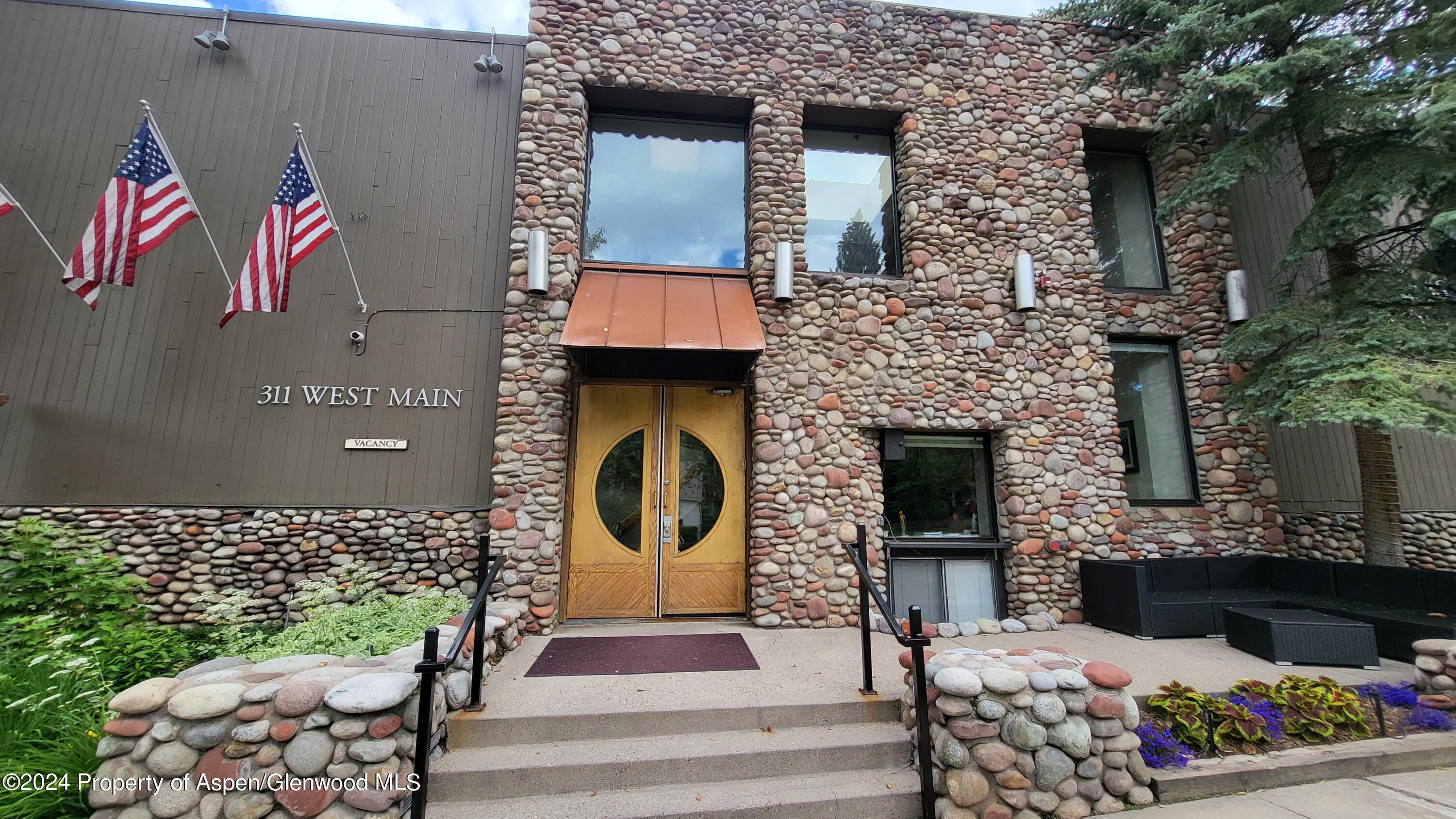 a front view of a house with outdoor seating