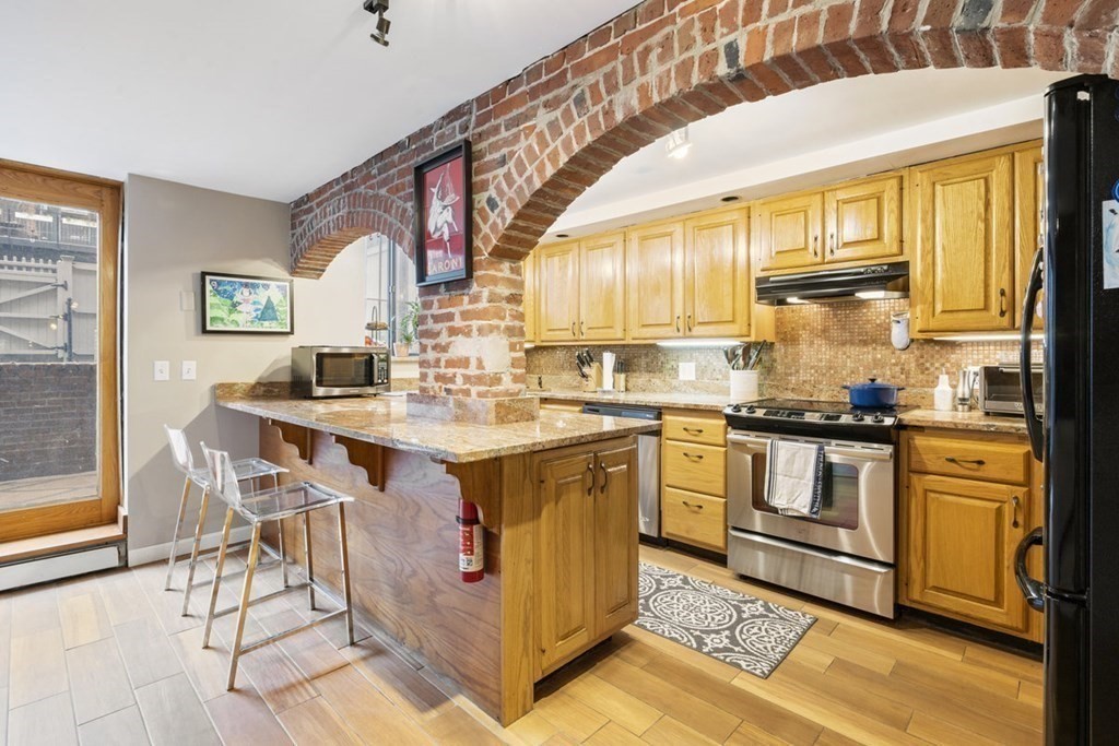 a kitchen with stainless steel appliances granite countertop a stove and a refrigerator