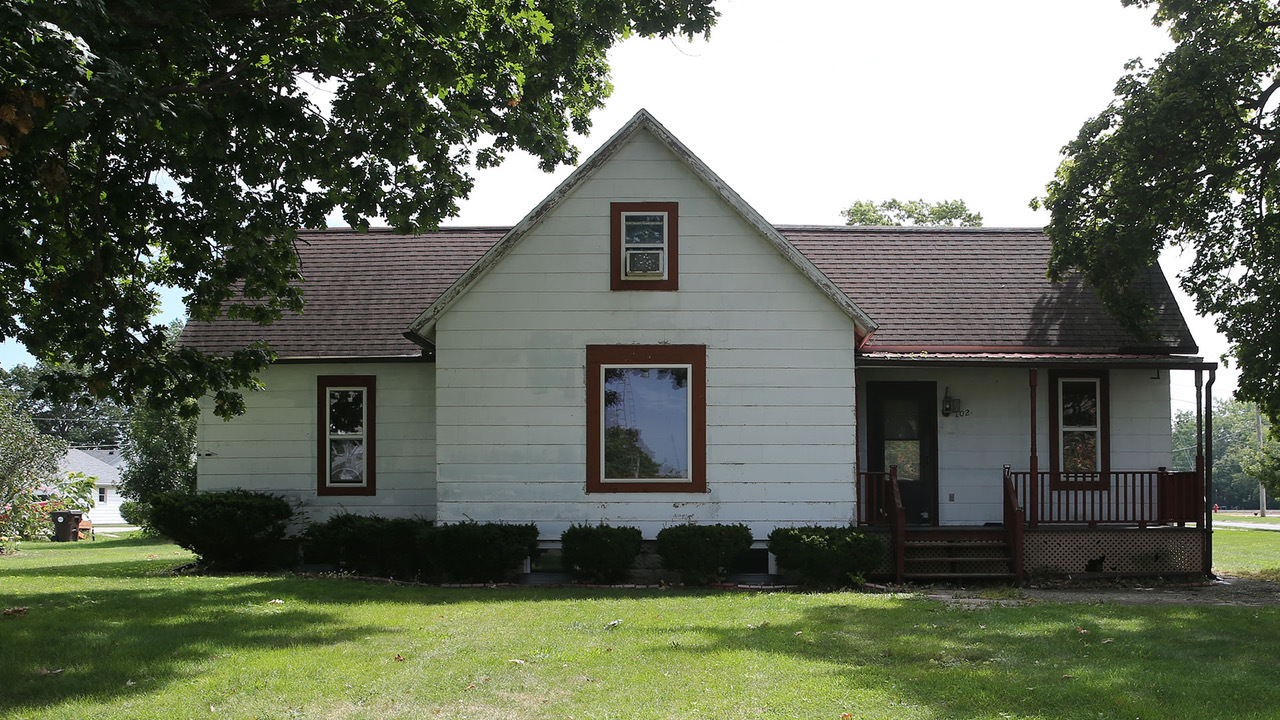 a front view of a house with a yard