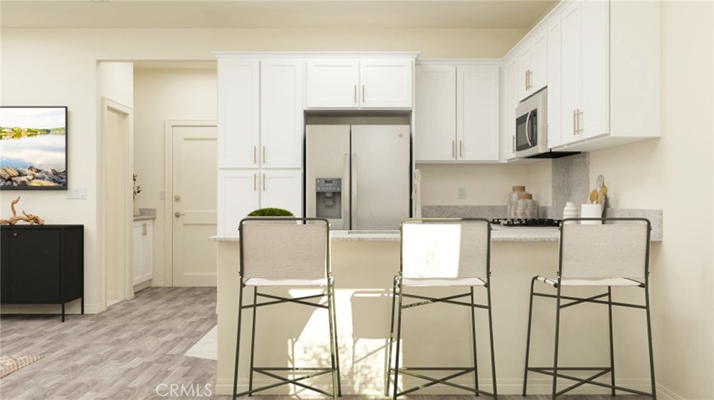 a kitchen with stainless steel appliances granite countertop a cabinets and a refrigerator