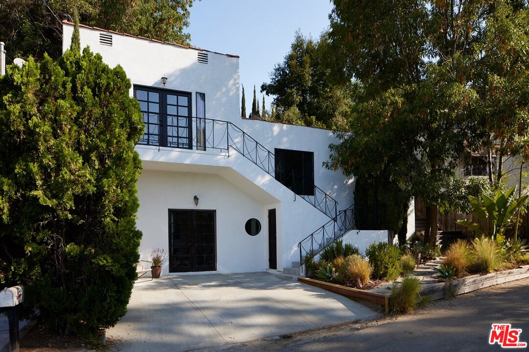 a front view of a house with a yard garage and outdoor seating