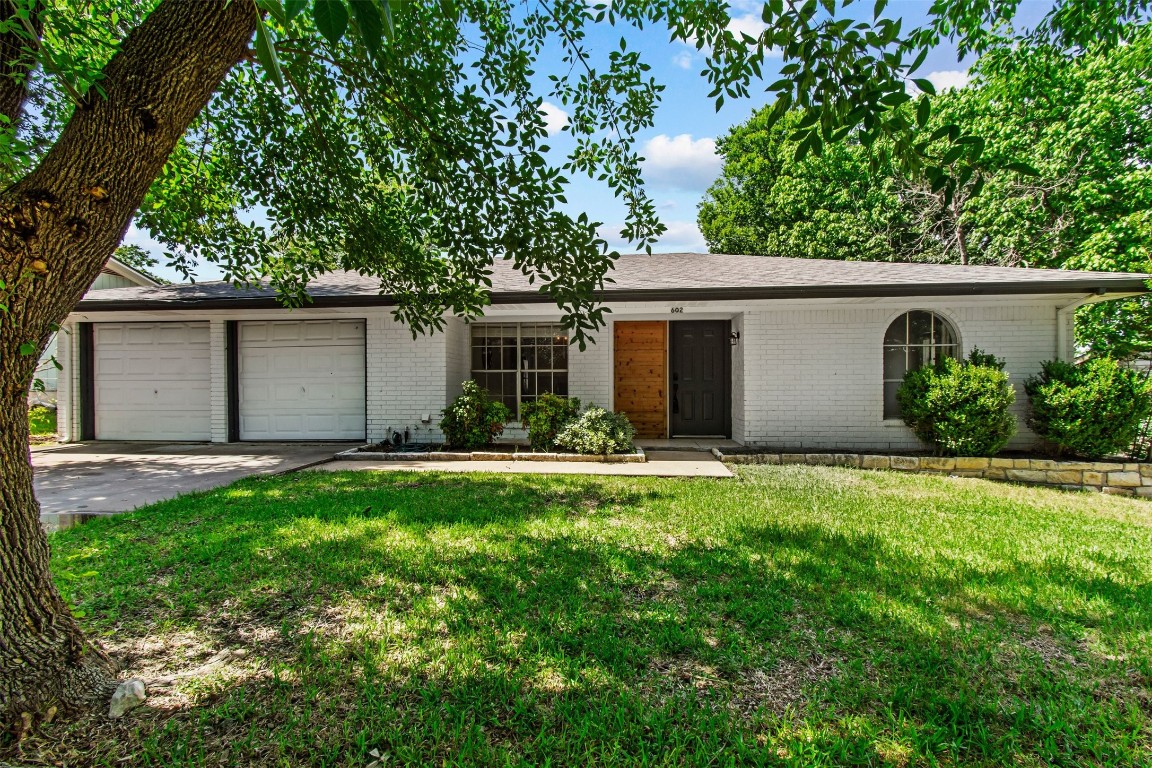 a front view of house with yard and green space