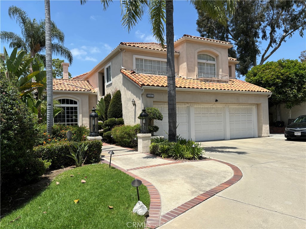 a front view of a house with a garden and plants