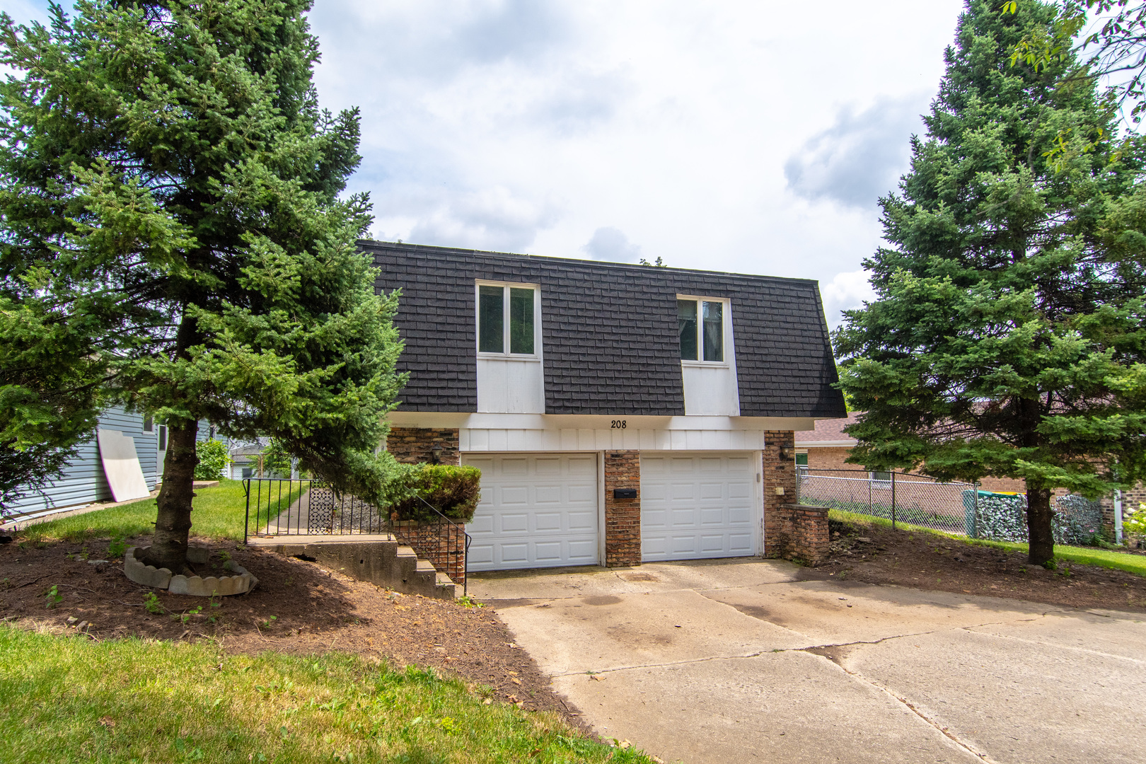 a front view of a house with a garage