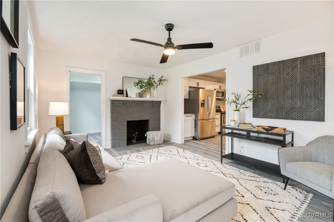 a living room with furniture and a fireplace