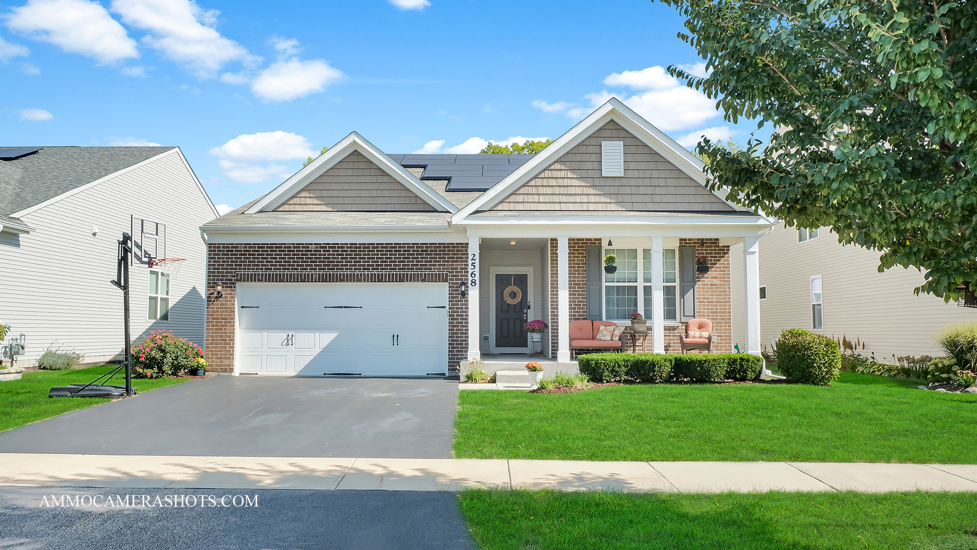 a front view of a house with a yard and garage