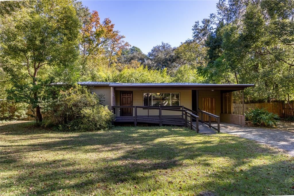 a view of a house with backyard porch and sitting area