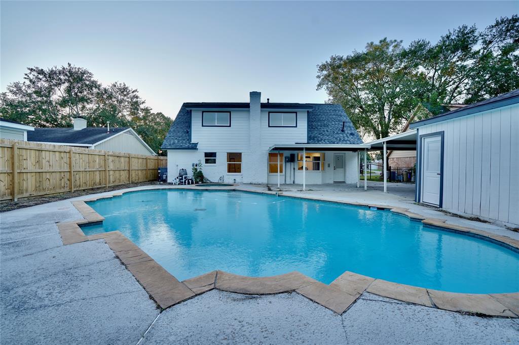 a view of pool with outdoor seating and deck