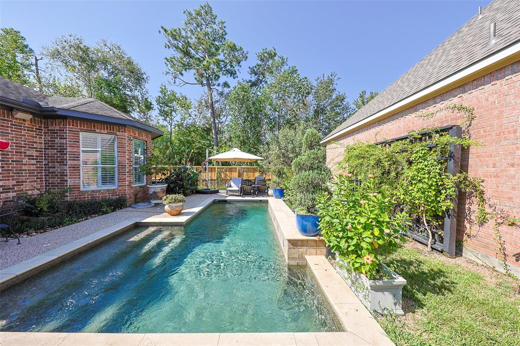 a view of a house with backyard sitting area and garden