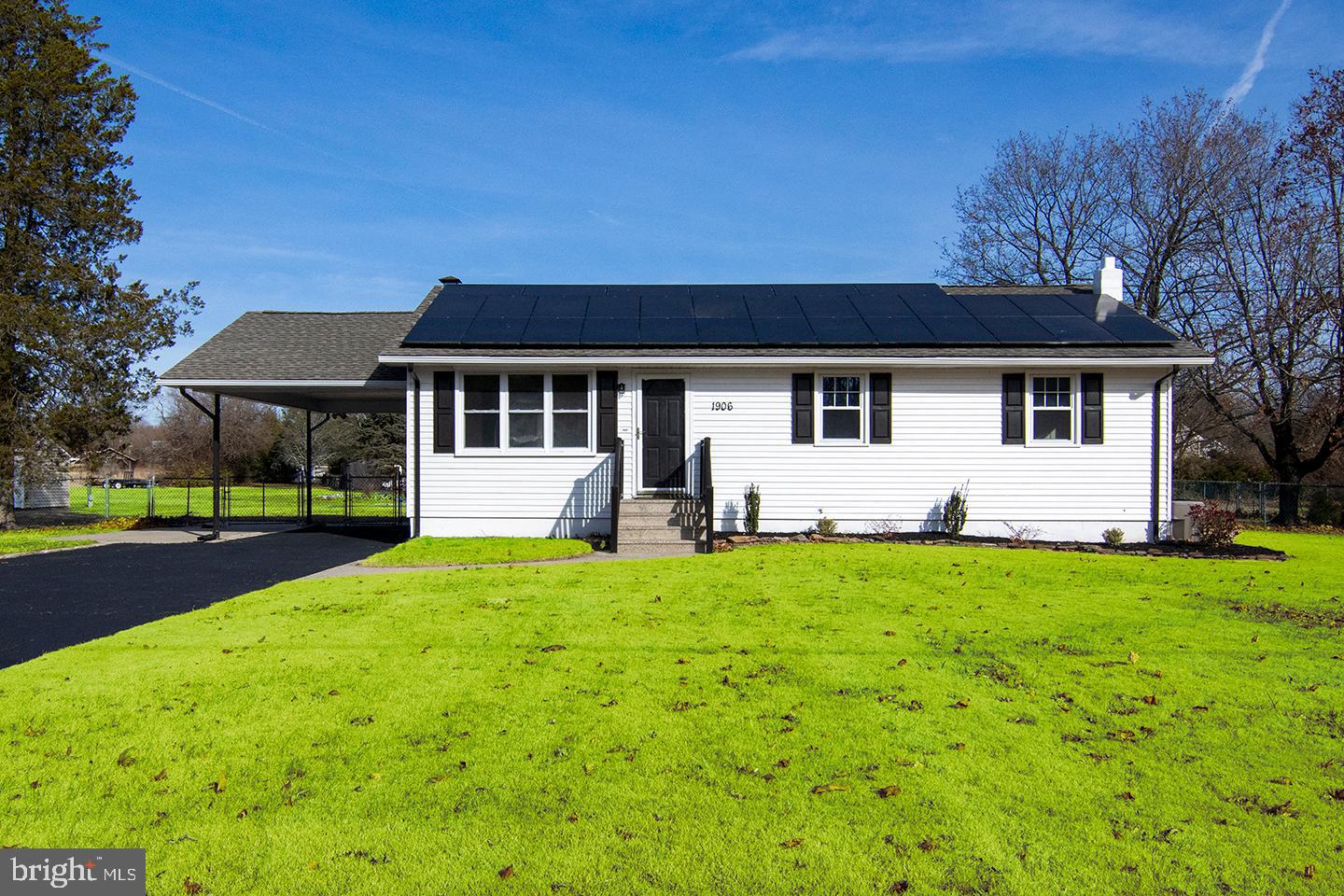 a front view of a house with yard and green space