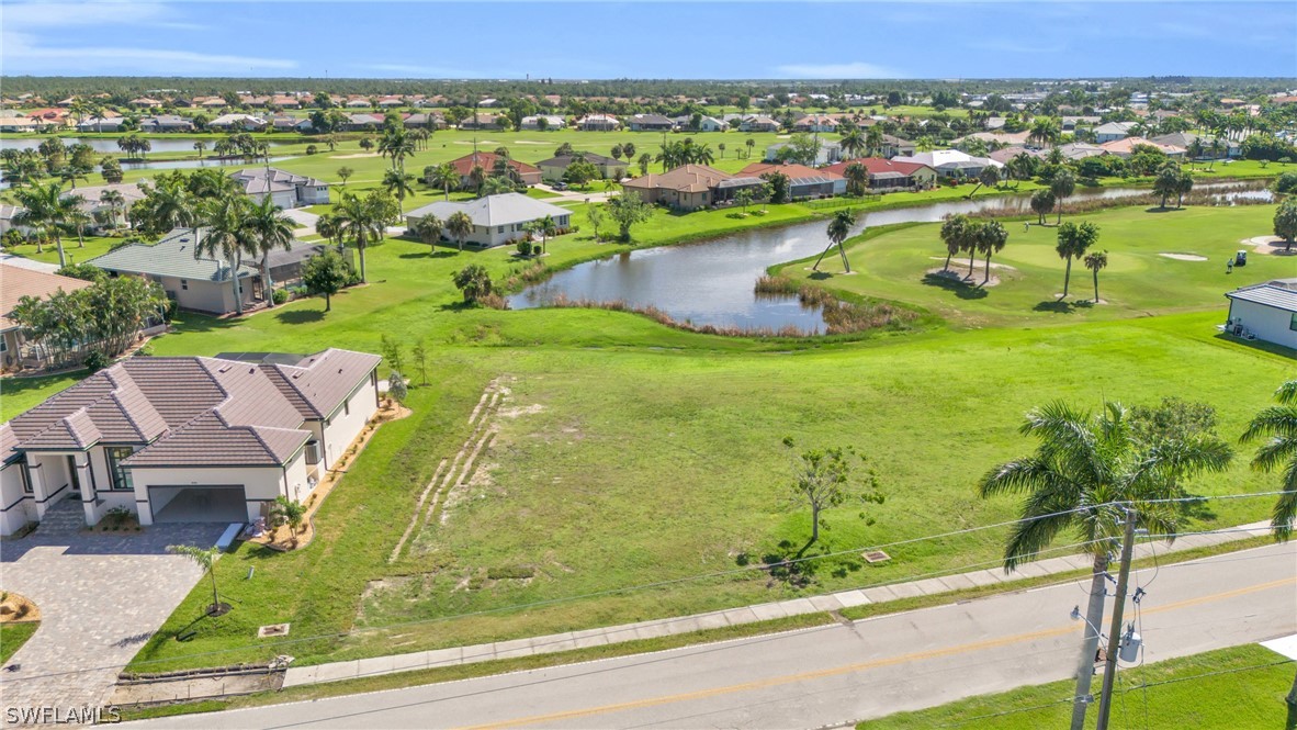 an aerial view of residential houses with outdoor space and swimming pool