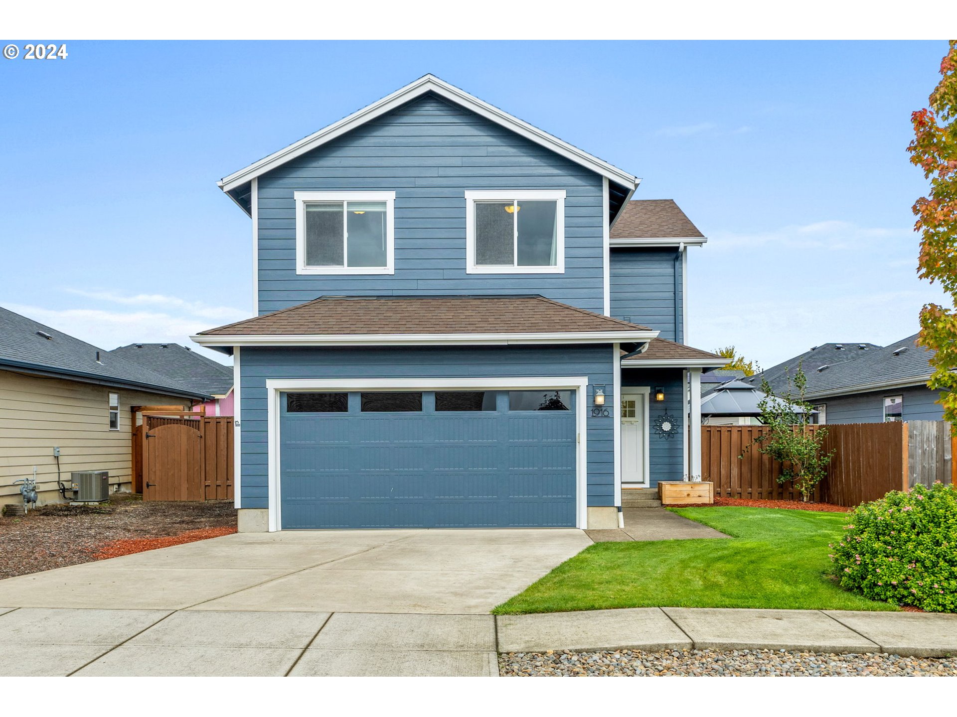 a view of a house with a yard and garage