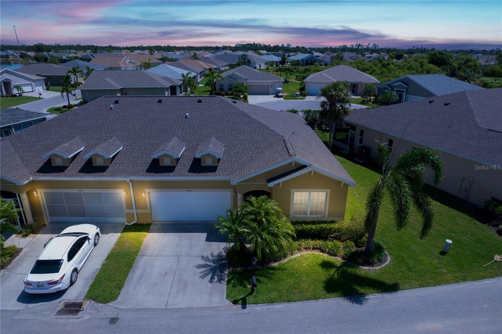 an aerial view of multiple houses with a yard