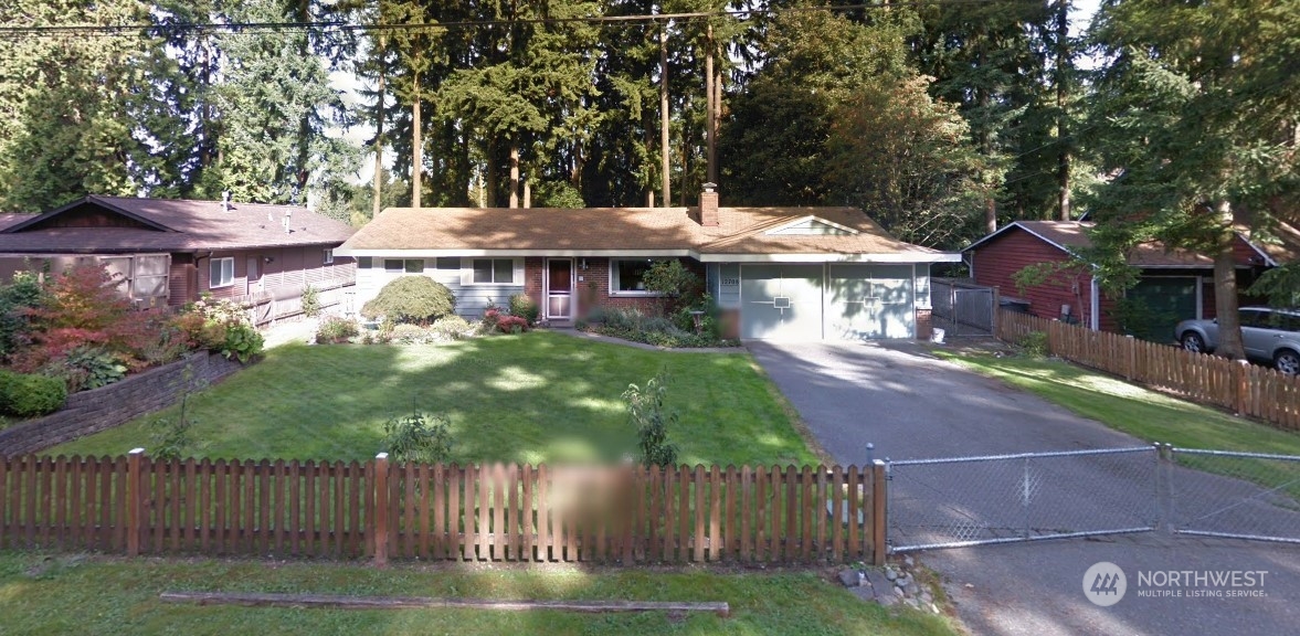 a front view of a house with a garden and yard