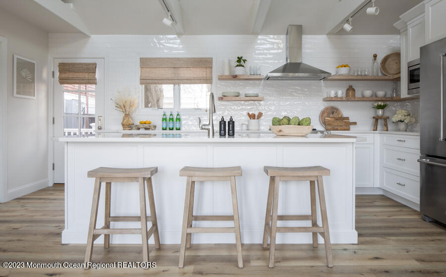 a kitchen with stainless steel appliances granite countertop a sink a stove and cabinets