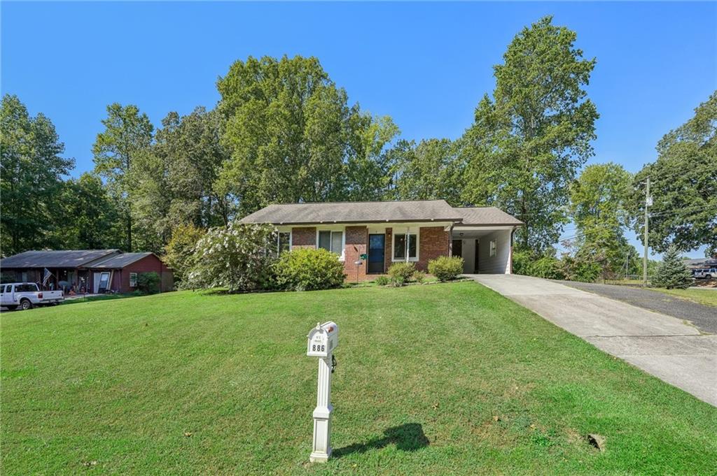 a front view of a house with yard porch and green space