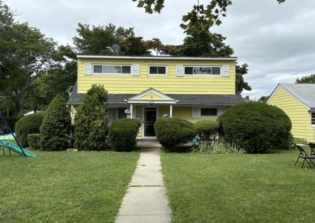 View of front of property with a front yard