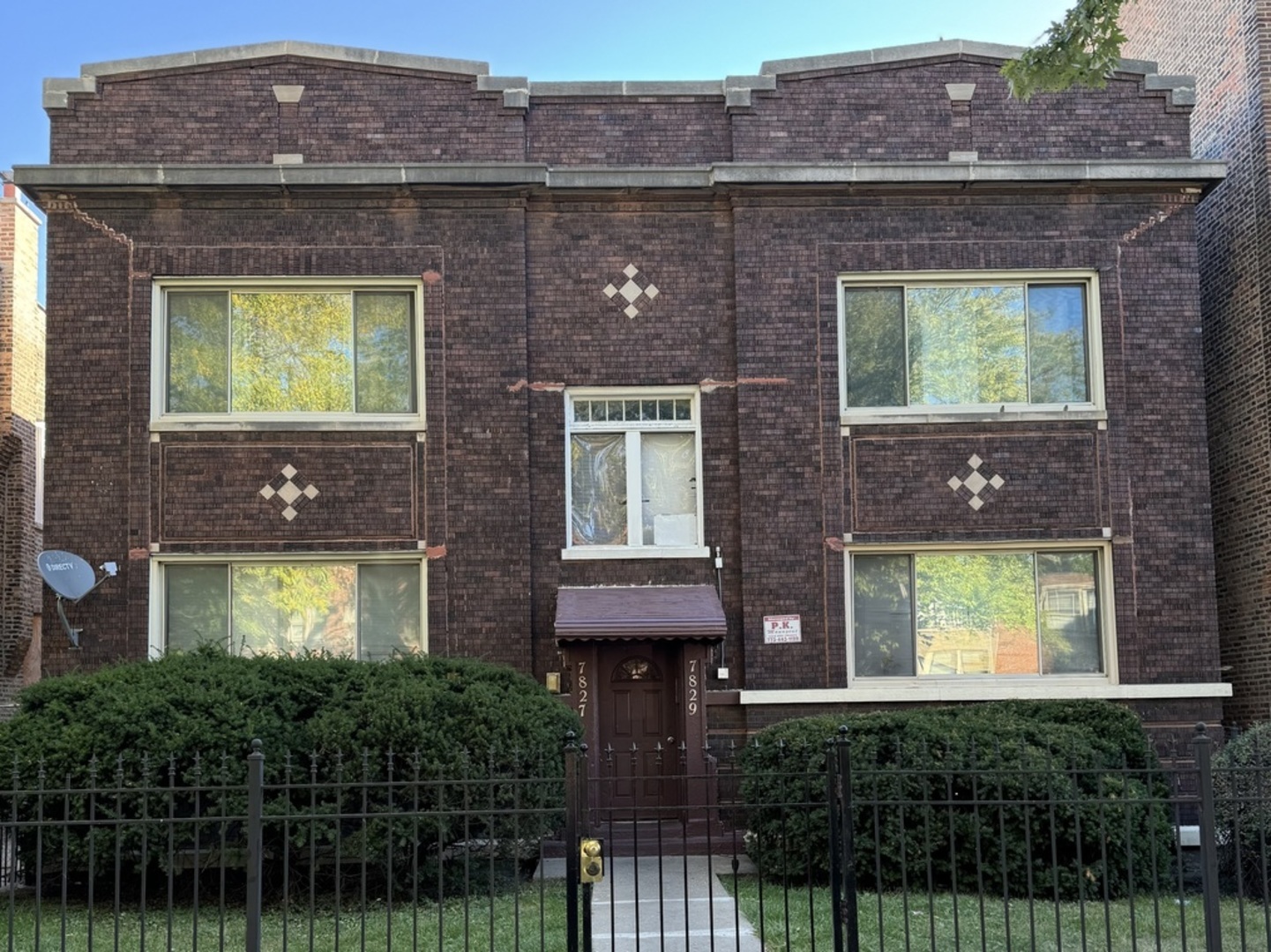 a front view of a house with a garden and plants