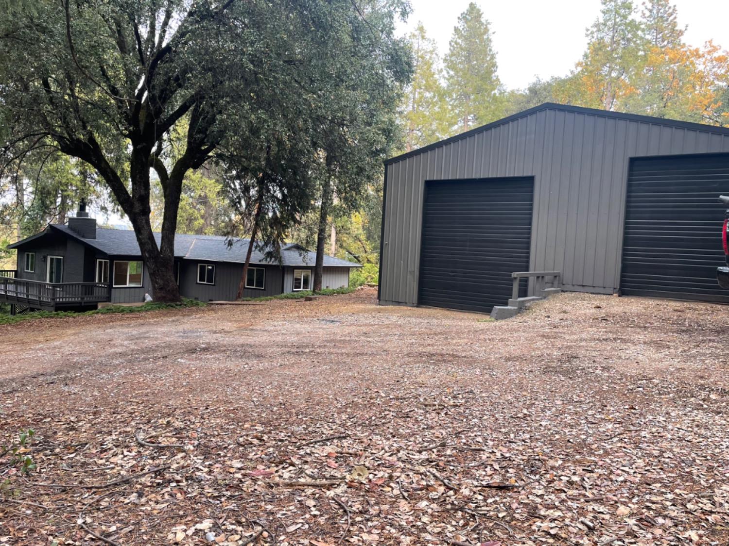 a front view of house with yard and trees in the background