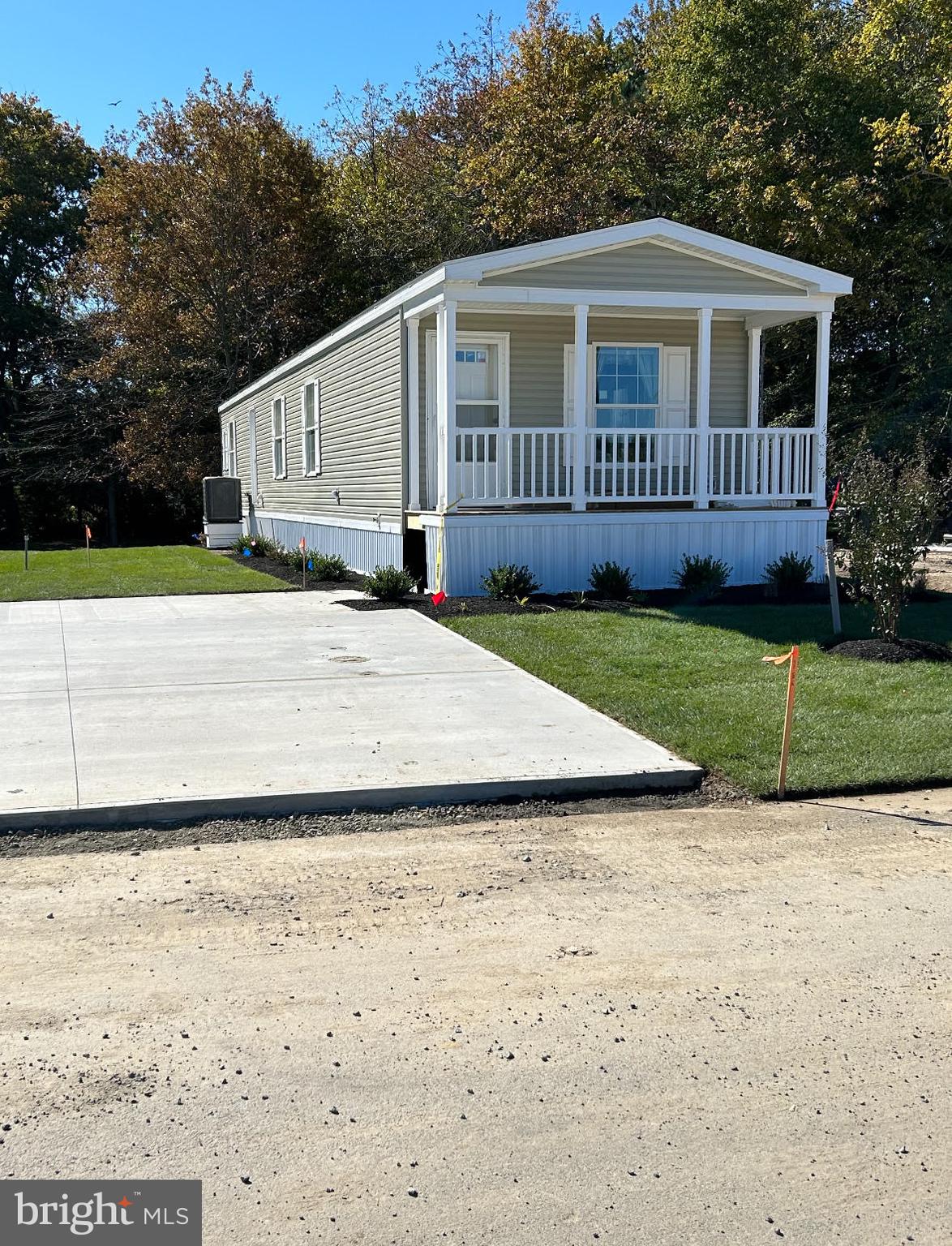 a front view of a house with a yard and trees