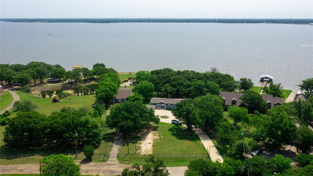 an aerial view of residential house with outdoor space and lake view