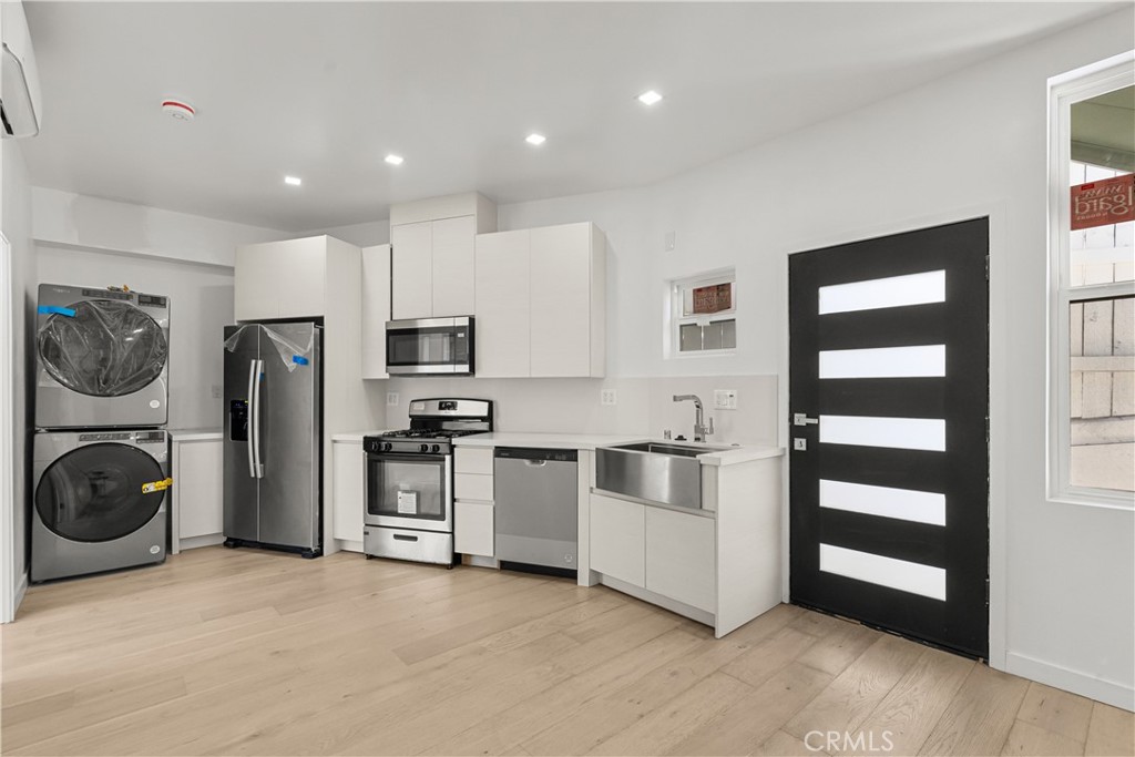 a kitchen with stainless steel appliances a stove a refrigerator and cabinets