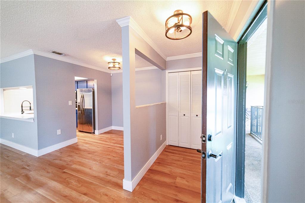 a view of a hallway with wooden floor