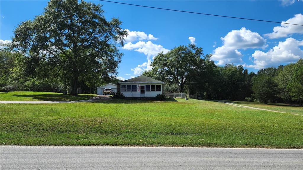 a view of a house with a yard