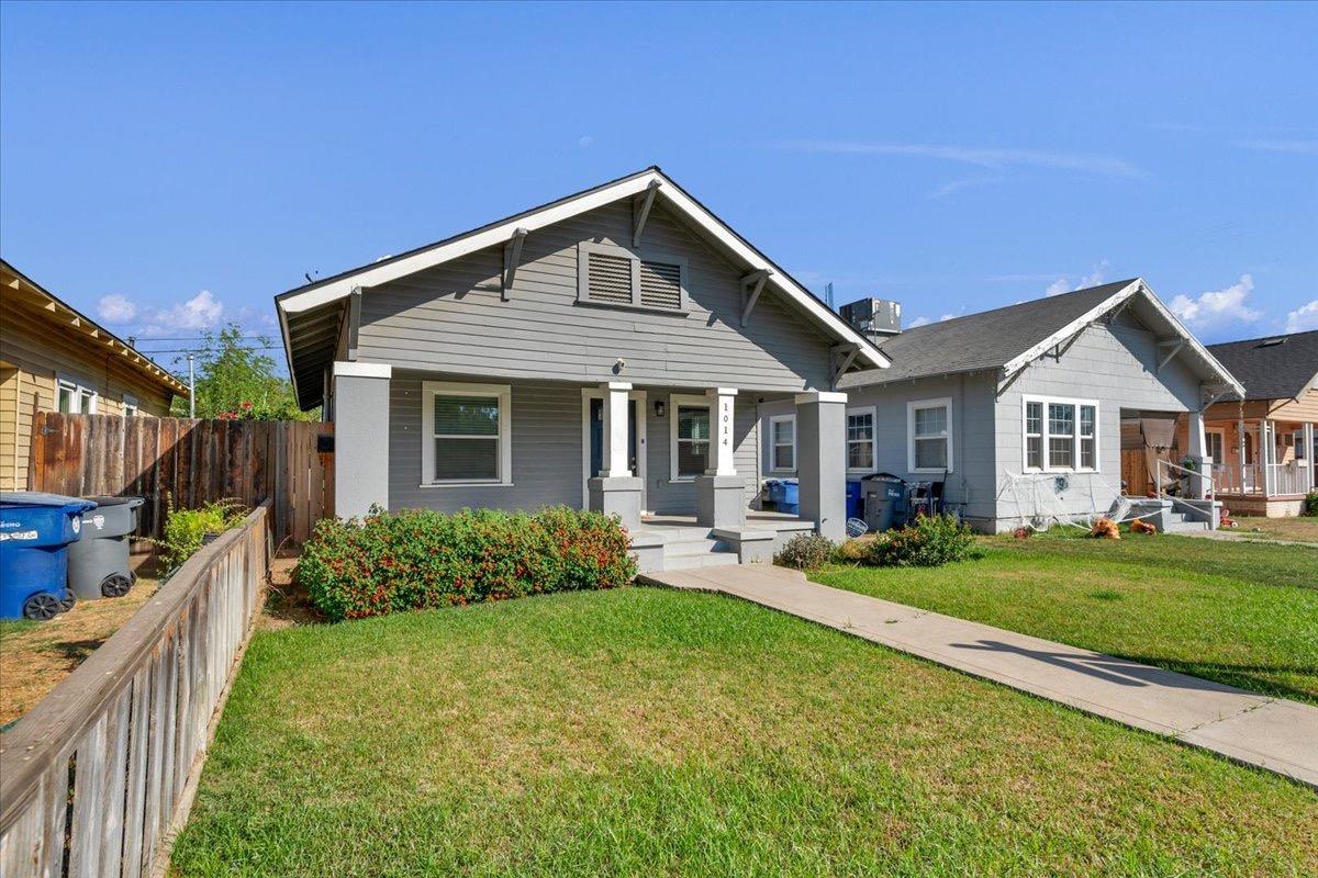 a front view of house with yard and green space