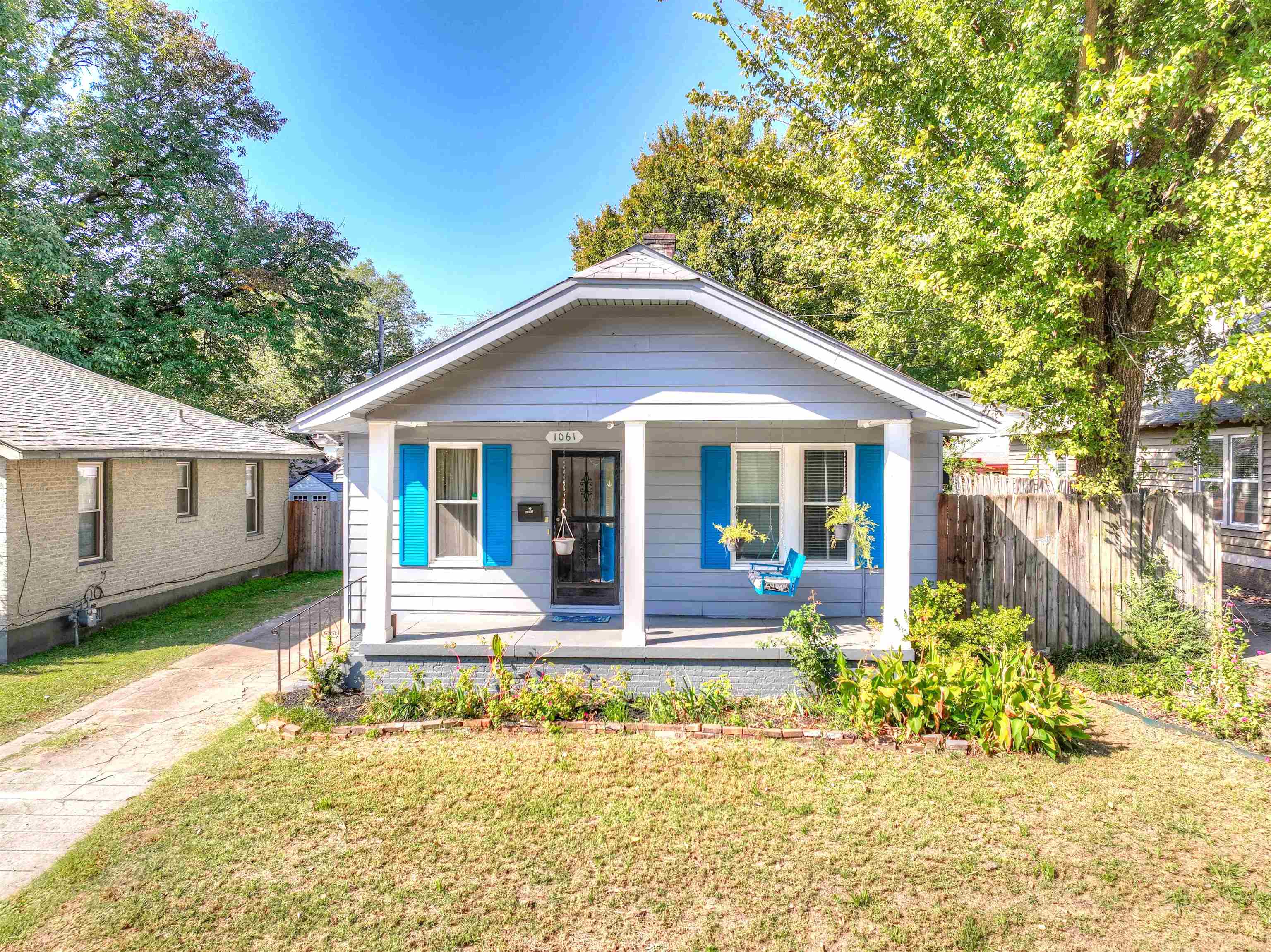 Bungalow with a front lawn and covered porch