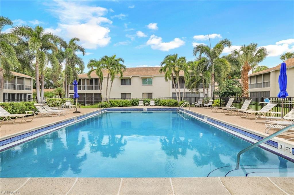 a swimming pool view with a outdoor seating