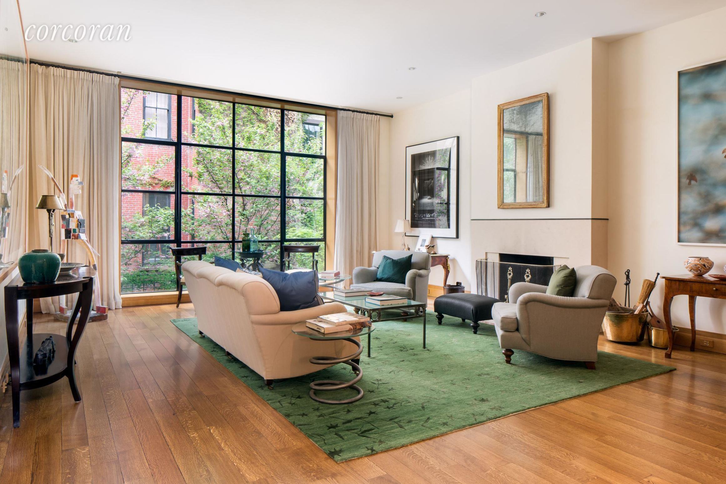 a living room with fireplace furniture and a large window