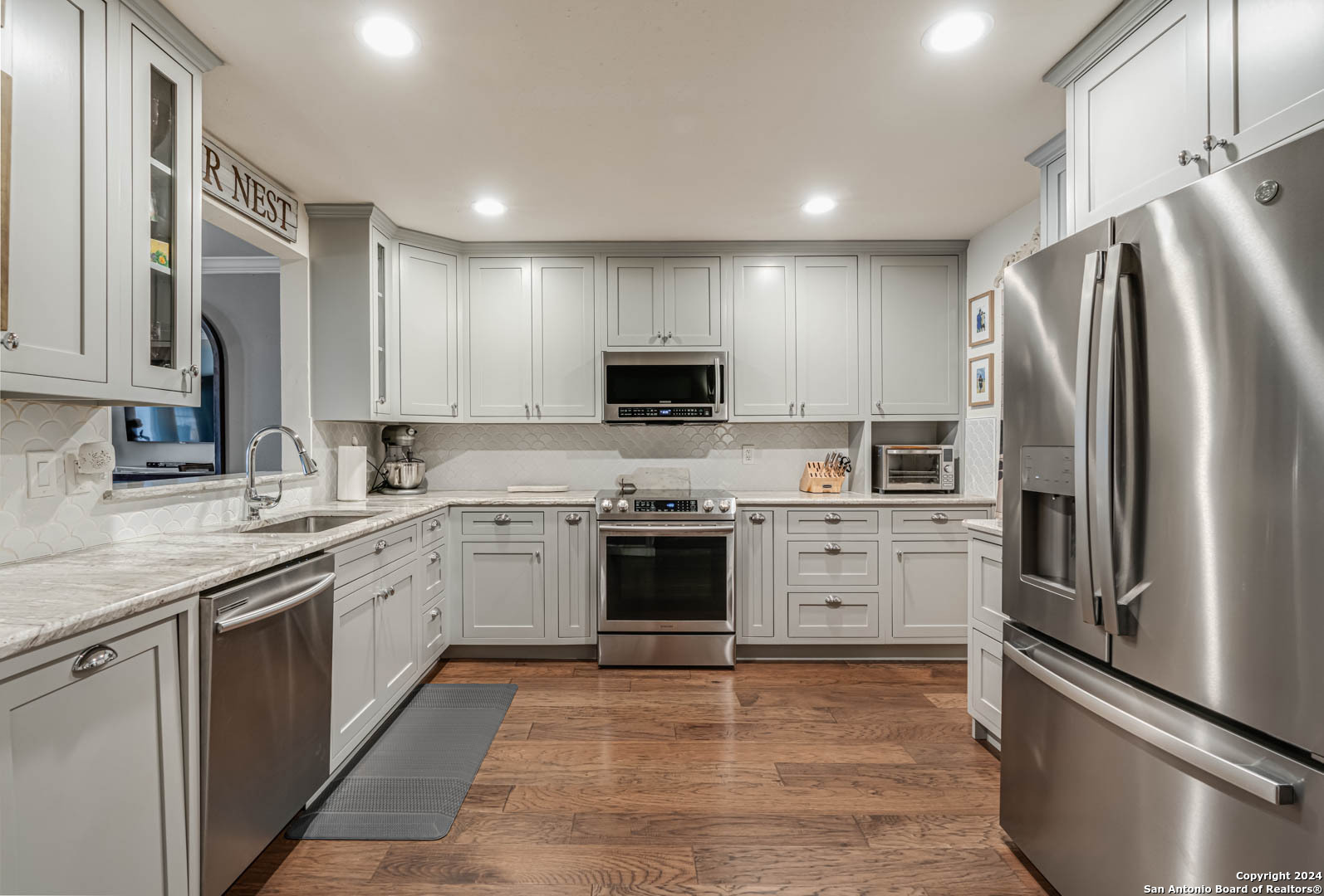 a kitchen with a stove top oven a sink and a refrigerator