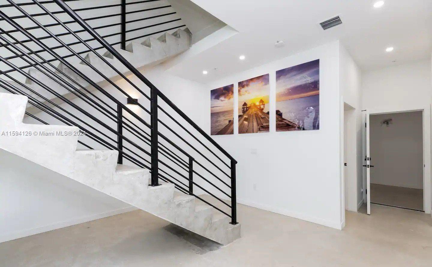 a view of a hallway with paintings on the wall