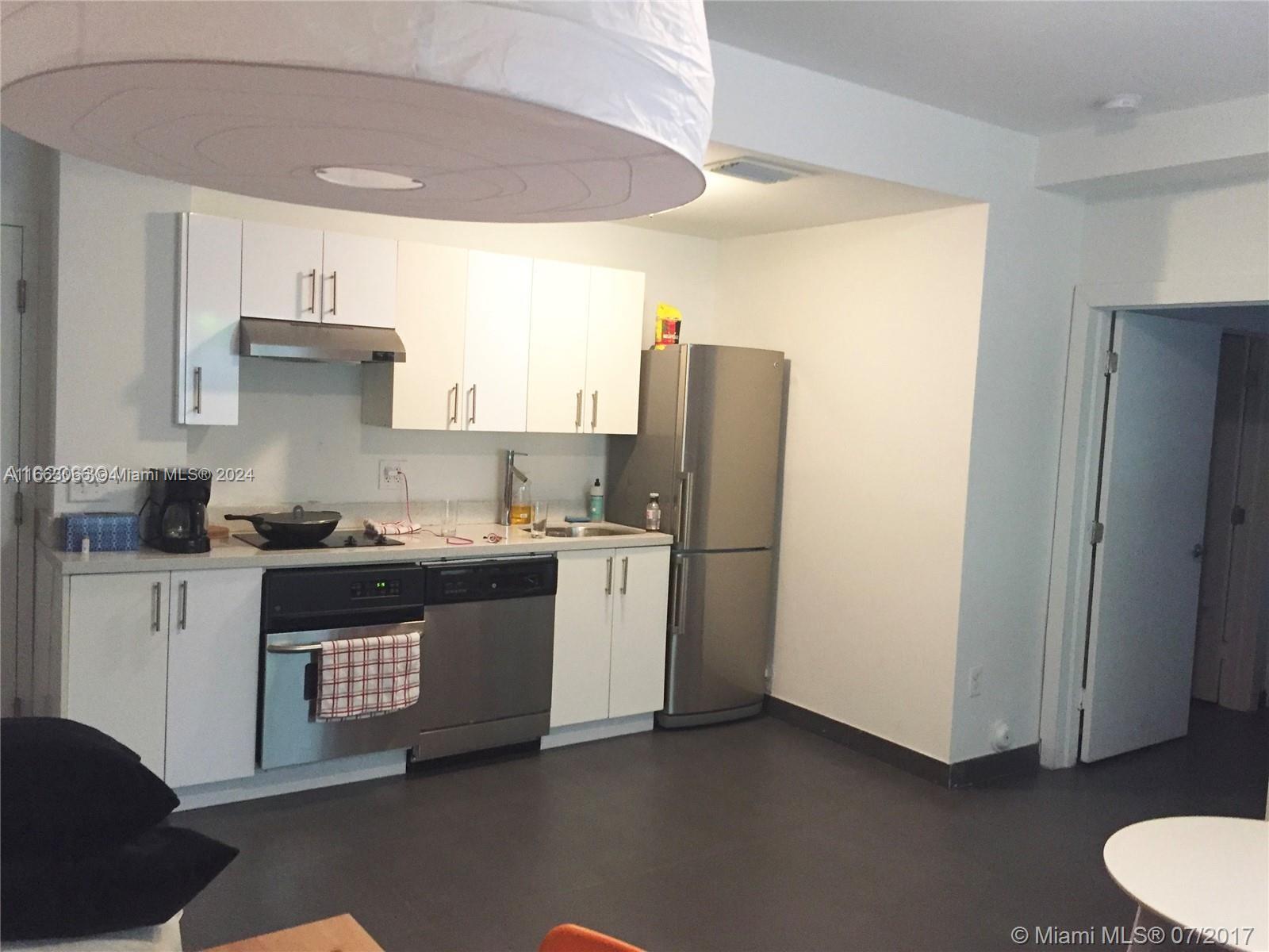 a kitchen with a refrigerator and a stove